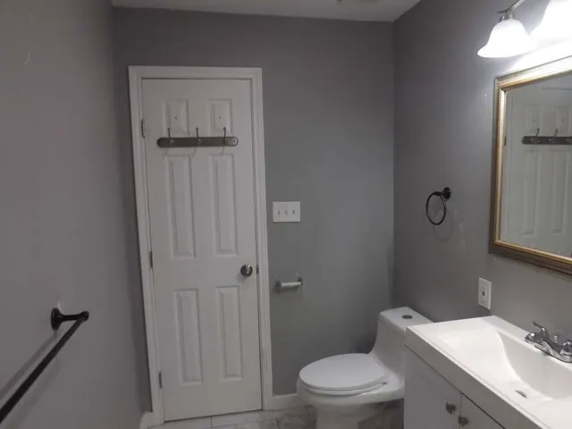 a bathroom with a toilet a sink and shower