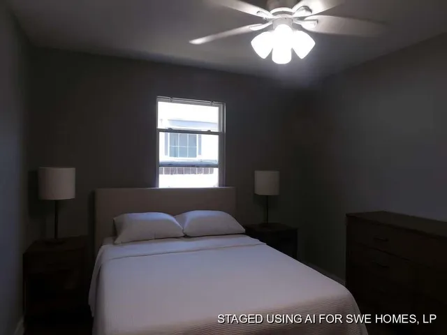 a bedroom with a bed and a lamp