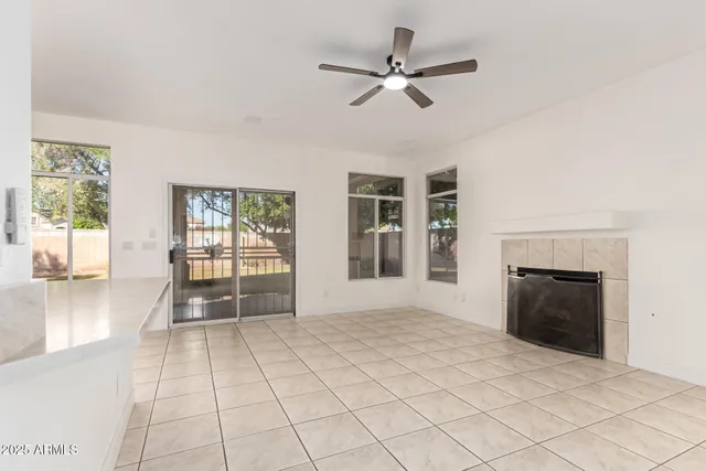 a view of an empty room with a fireplace and a window
