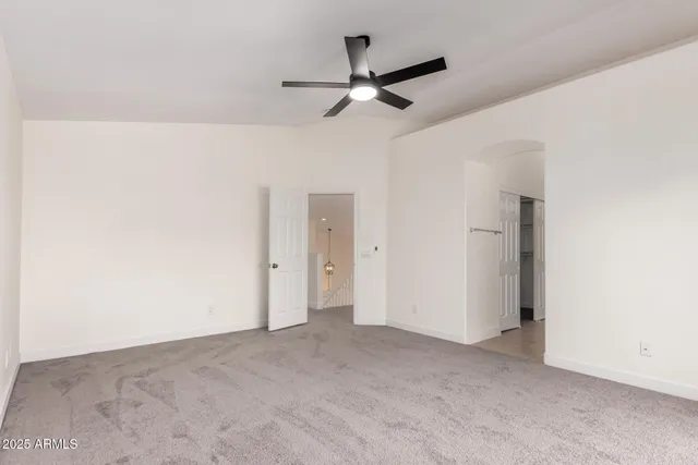 a view of a big room with a ceiling fan