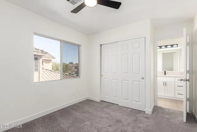 an empty room with windows and closet