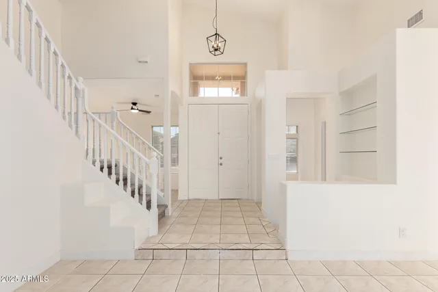 a view of hallway with stairs and wooden floor