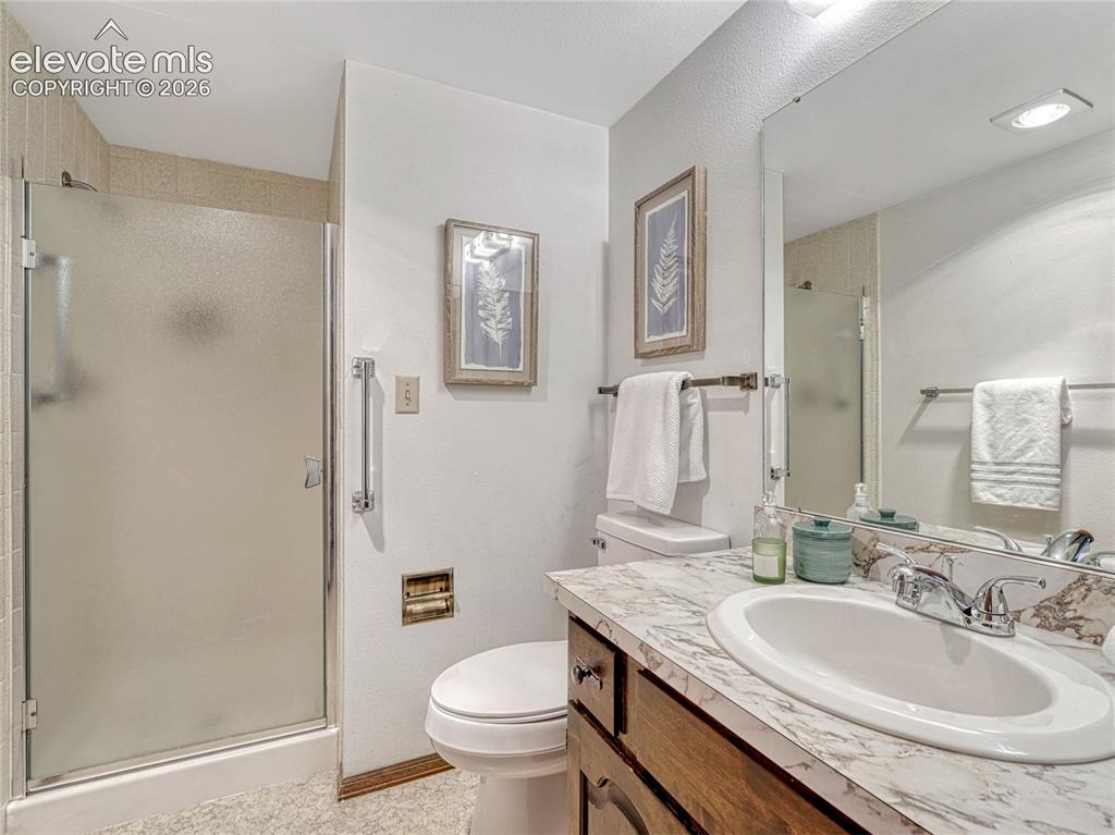 1146 Fontmore Road, Unit A Colorado Springs, CO 80904 - Photo 24 of 24 a bathroom with a granite countertop sink toilet and shower