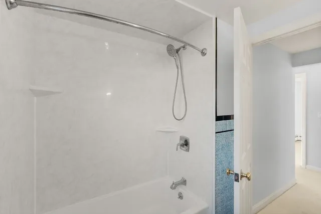 a bathroom with a shower and a shower