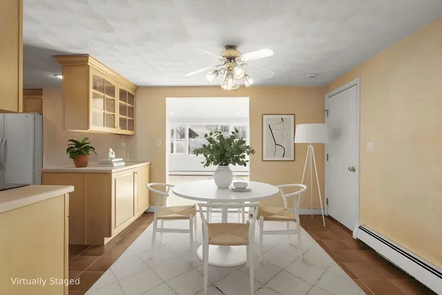 a view of a dining room with furniture and a chandelier