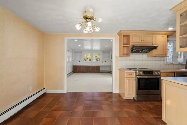 a kitchen with kitchen island granite countertop a stove a sink and a refrigerator