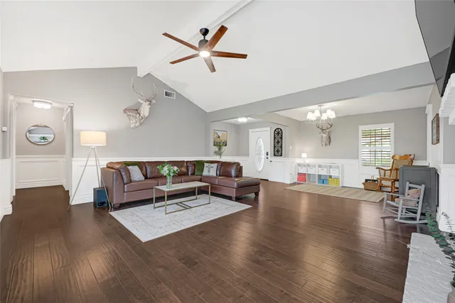a living room with furniture a flat screen tv and a fireplace