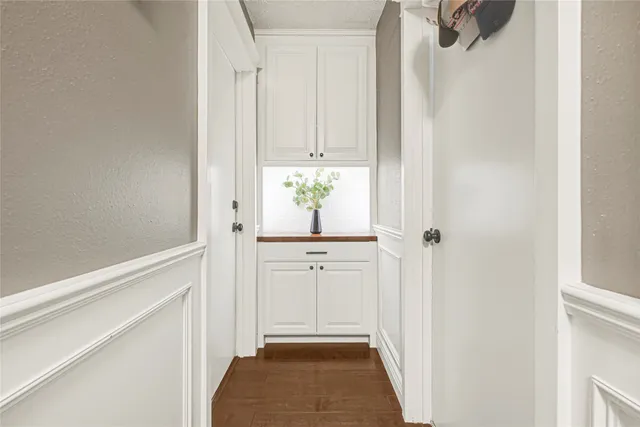 a bathroom with a granite countertop toilet sink and mirror