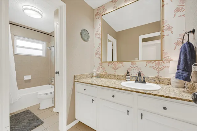 a bed room with a bed and a chair