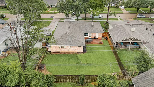 an aerial view of a house with a yard pool patio and outdoor seating