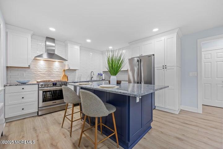 283 Spring Street, Unit 3A Red Bank, NJ 07701 - Photo 1 of 20 a kitchen with kitchen island granite countertop a sink cabinets and stainless steel appliances