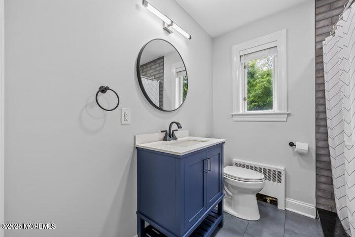 283 Spring Street, Unit 3A Red Bank, NJ 07701 - Photo 16 of 20 a bathroom with a toilet sink and mirror