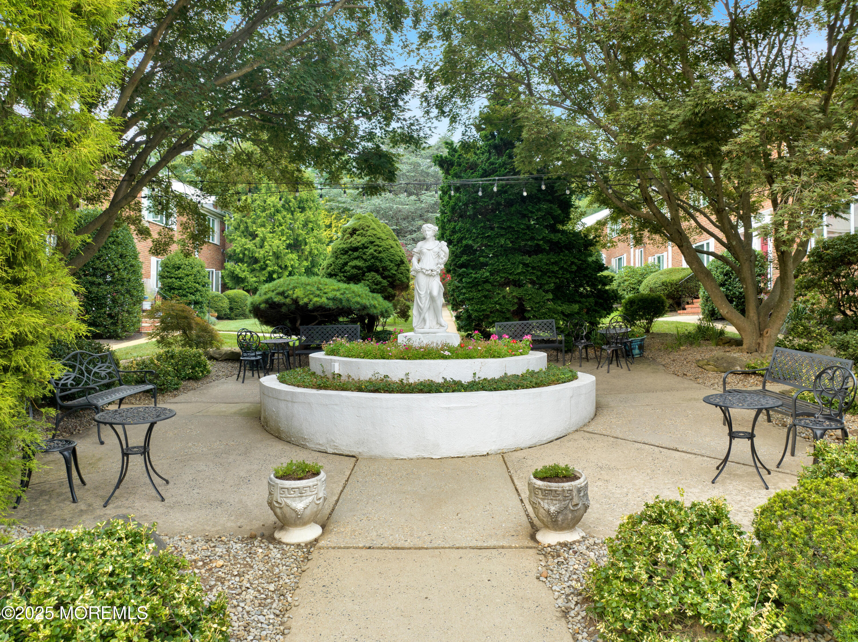 283 Spring Street, Unit 3A Red Bank, NJ 07701 - Photo 18 of 20 a view of a swimming pool with a garden