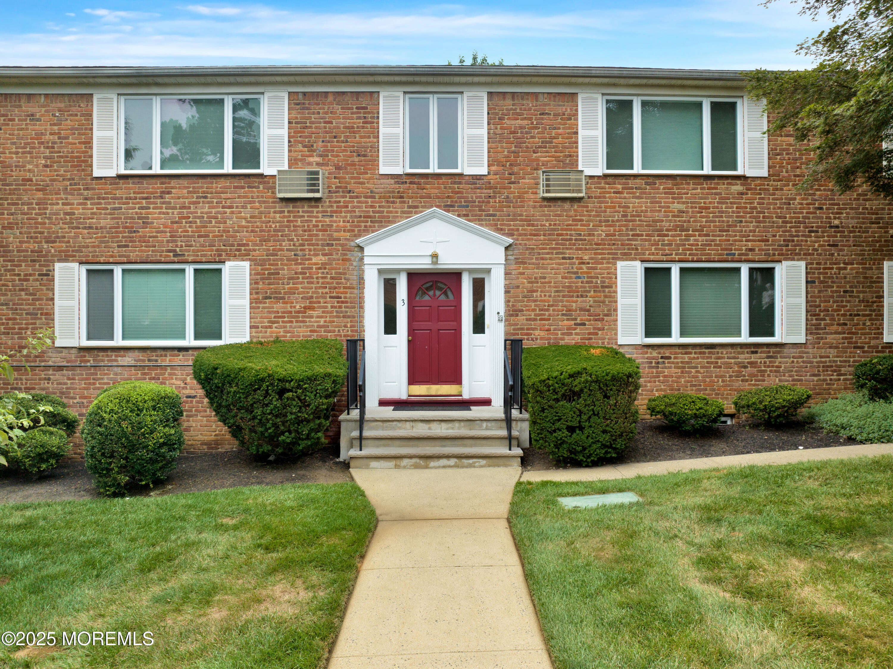 283 Spring Street, Unit 3A Red Bank, NJ 07701 - Photo 20 of 20 a front view of a house with garden