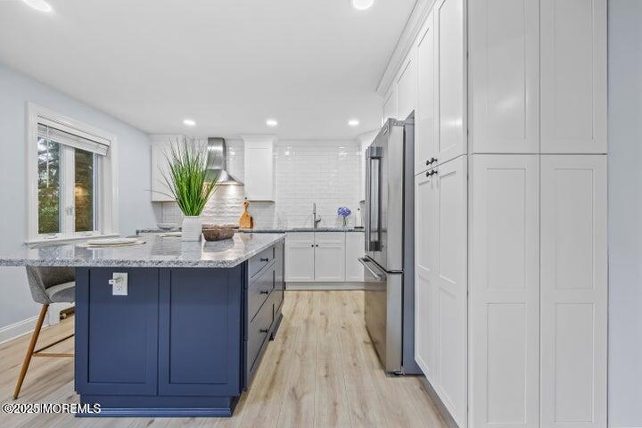 283 Spring Street, Unit 3A Red Bank, NJ 07701 - Photo 6 of 20 a kitchen with kitchen island granite countertop a sink appliances and cabinets