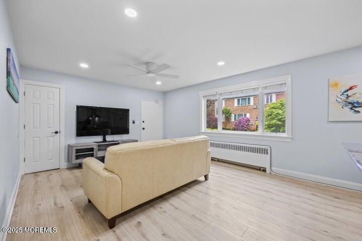 283 Spring Street, Unit 3A Red Bank, NJ 07701 - Photo 9 of 20 a living room with furniture and a flat screen tv