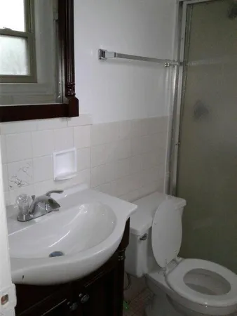 a bathroom with a sink a toilet and mirror