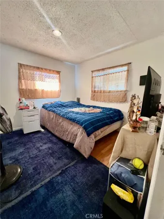 a kitchen with stainless steel appliances a stove refrigerator sink and white cabinets