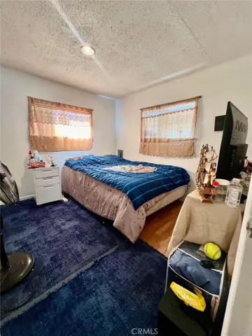 a kitchen with stainless steel appliances a stove refrigerator sink and white cabinets