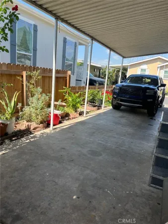 a view of a house with a cars park side of a road