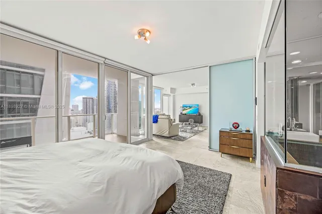 a bathroom with a tub a double vanity sink and mirror