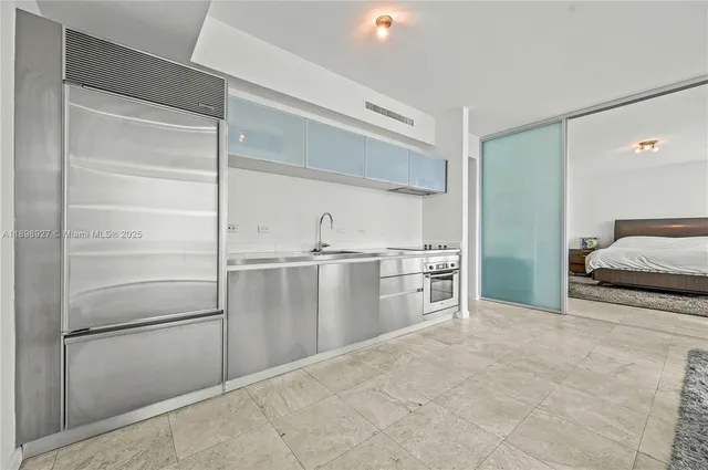 a kitchen with granite countertop a stove and cabinets
