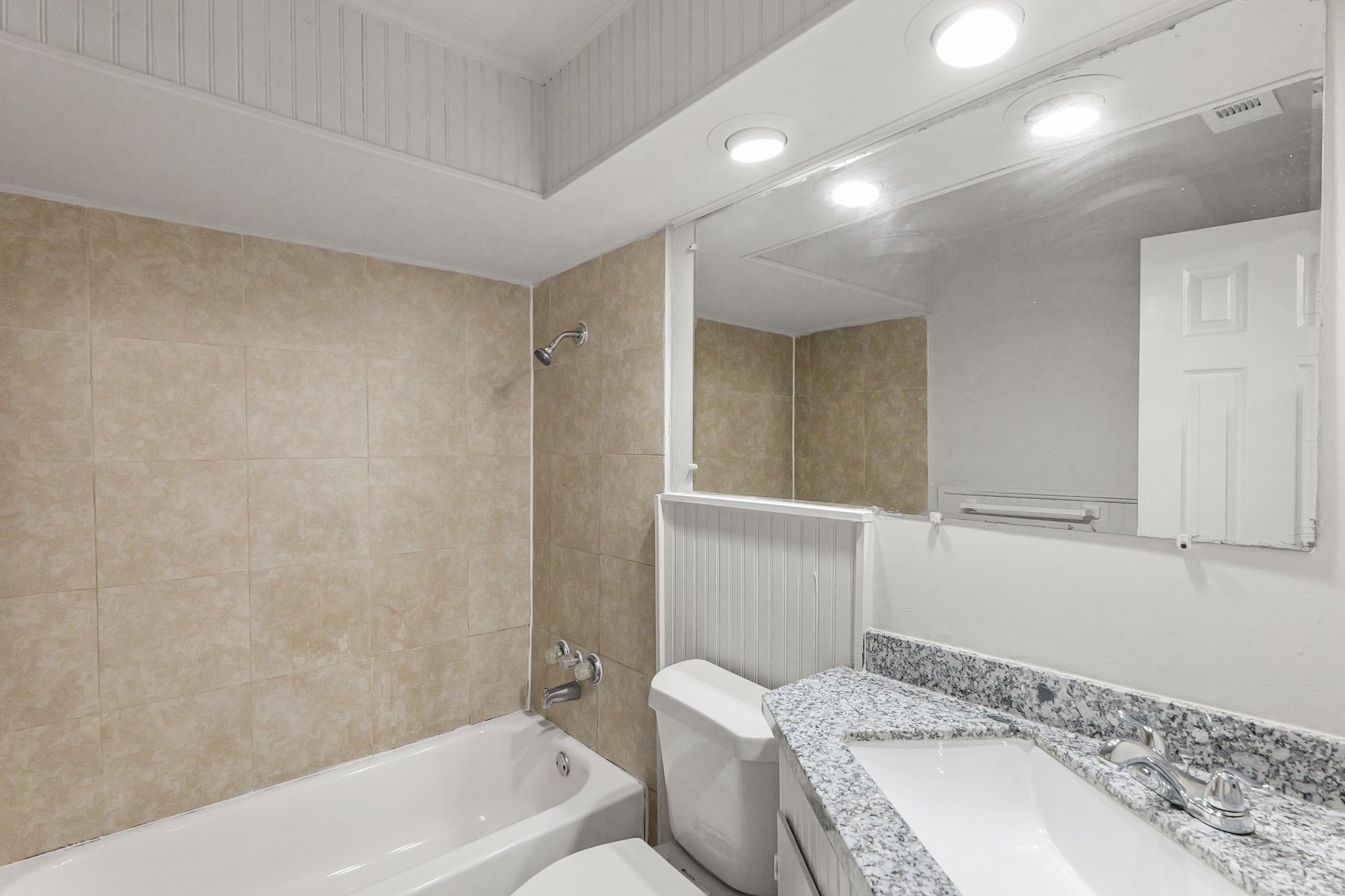 414 Grantham Road Baytown, TX 77521 - Photo 12 of 19 a bathroom with a granite countertop sink a toilet and bathtub