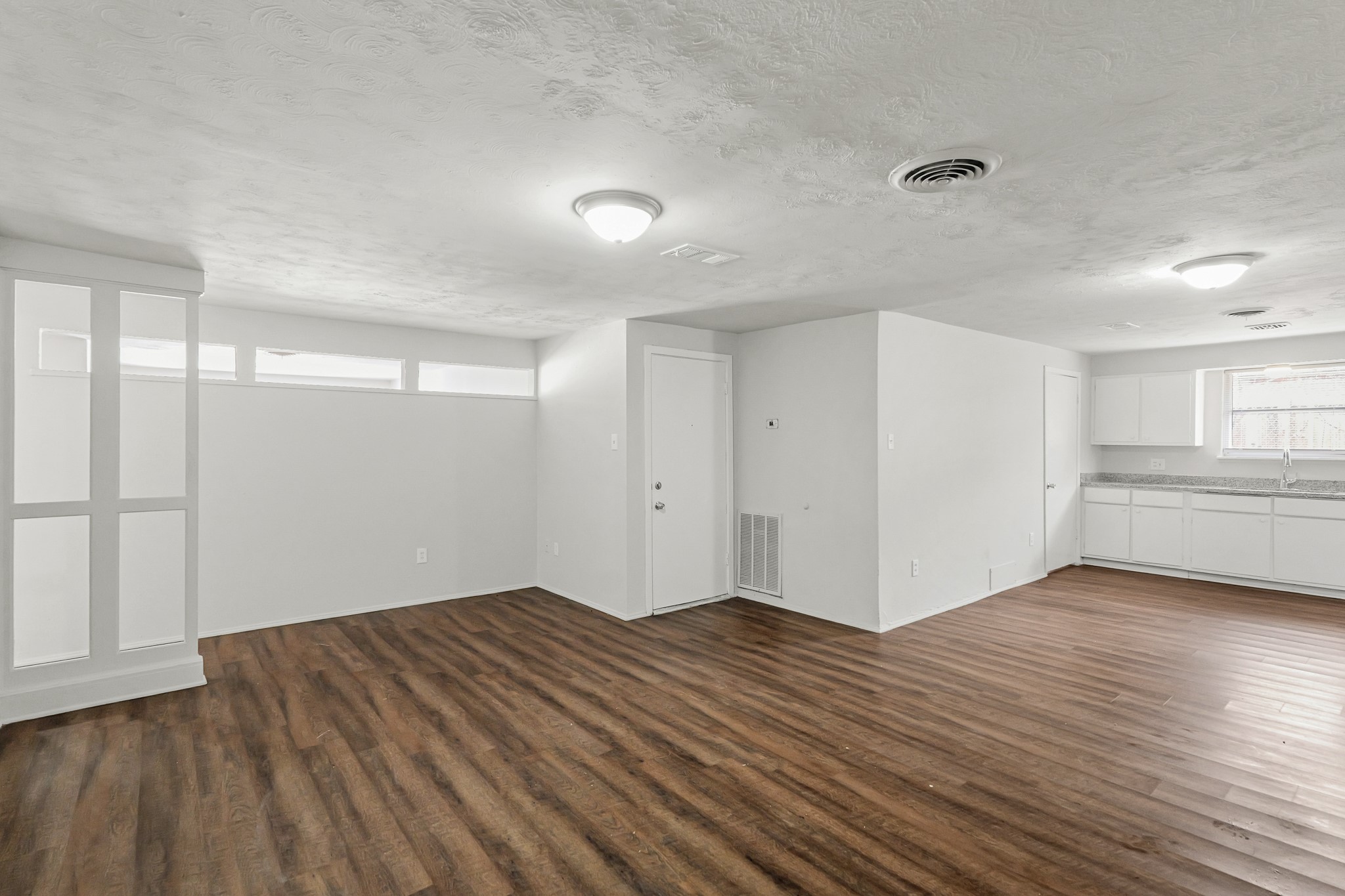 414 Grantham Road Baytown, TX 77521 - Photo 3 of 19 a view of empty room with wooden floor and fan