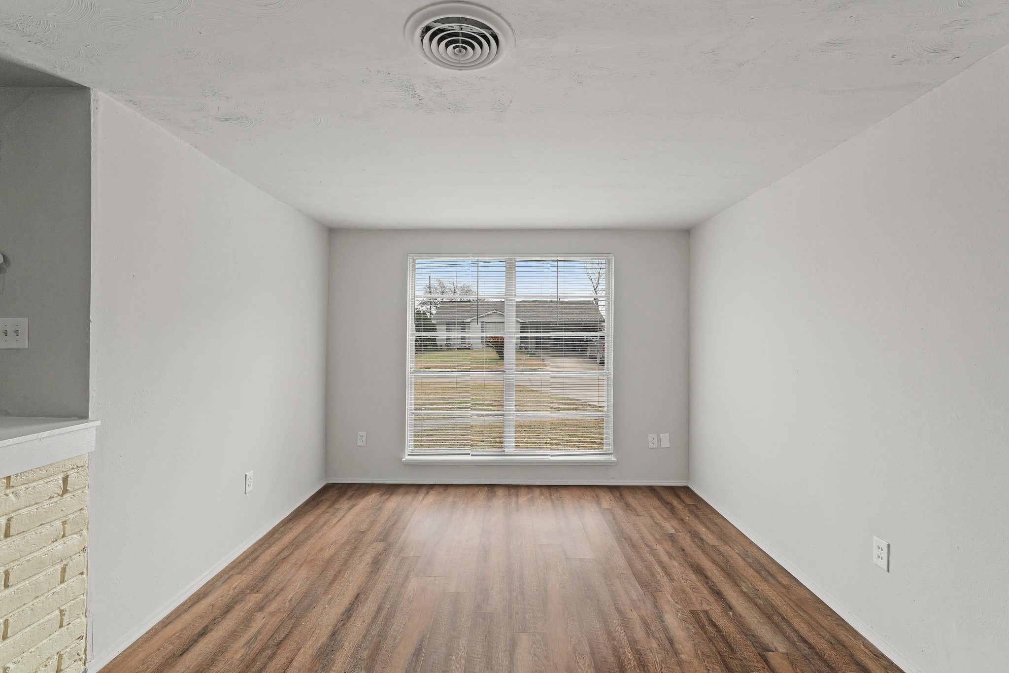 414 Grantham Road Baytown, TX 77521 - Photo 6 of 19 an empty room with wooden floor and windows