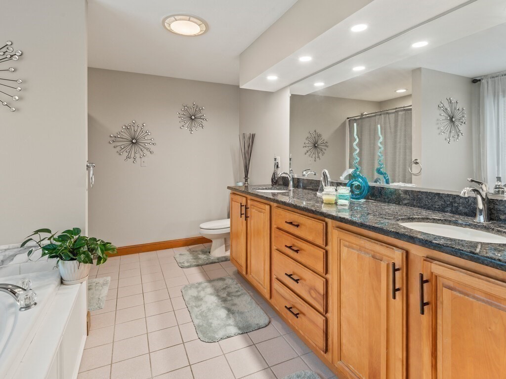 9 Santom Street Auburn, MA 01501 - Photo 19 of 42 a spacious bathroom with a granite countertop sink a toilet and a mirror