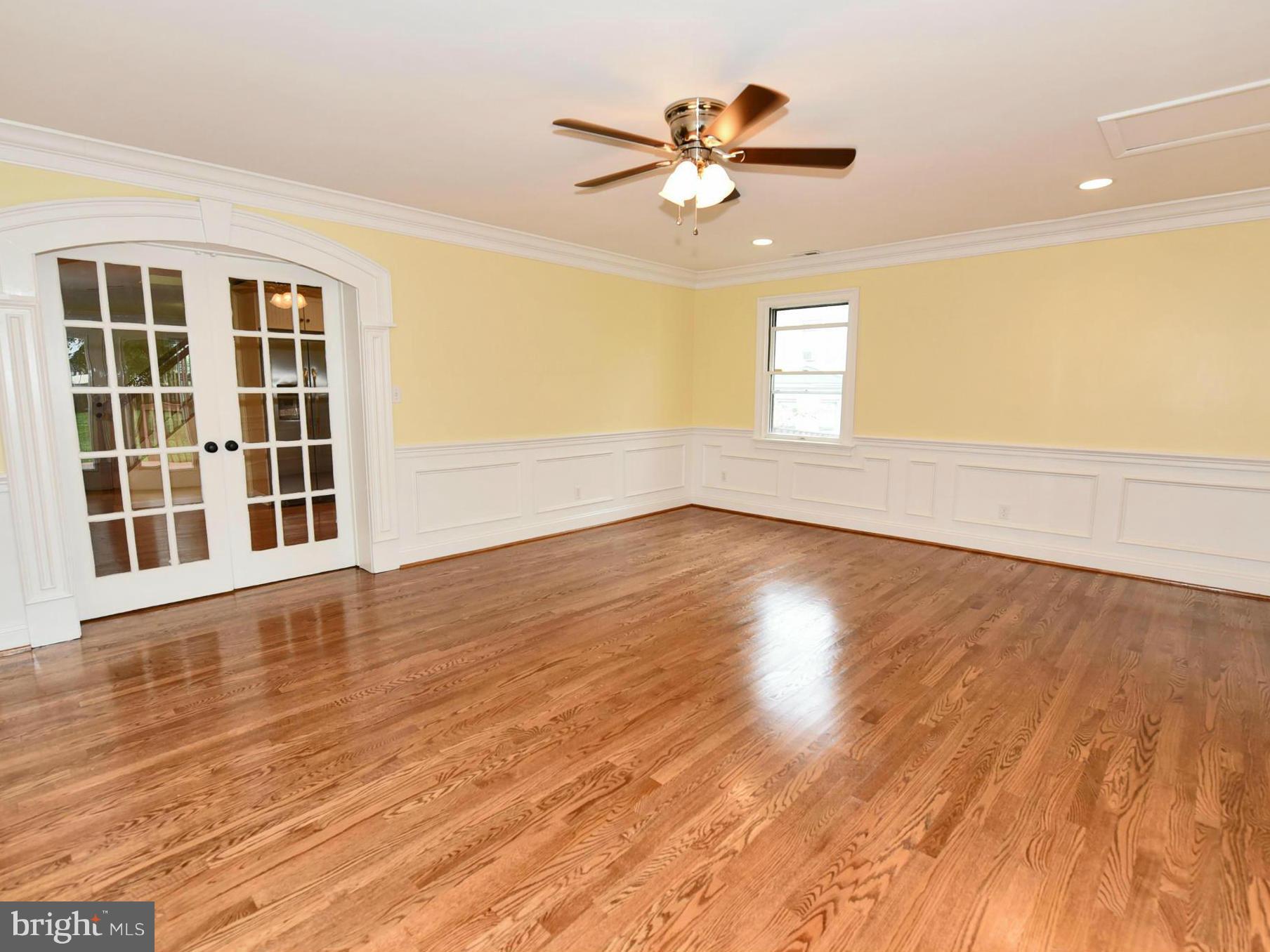 2138 Spencerville Road Spencerville, MD 20868 - Photo 12 of 30 a view of an empty room with wooden floor and a window