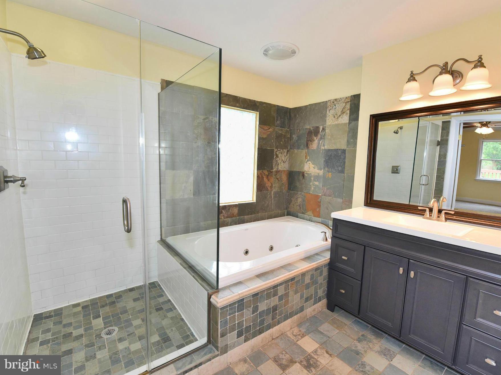 2138 Spencerville Road Spencerville, MD 20868 - Photo 15 of 30 a bathroom with a tub sink shower and mirror