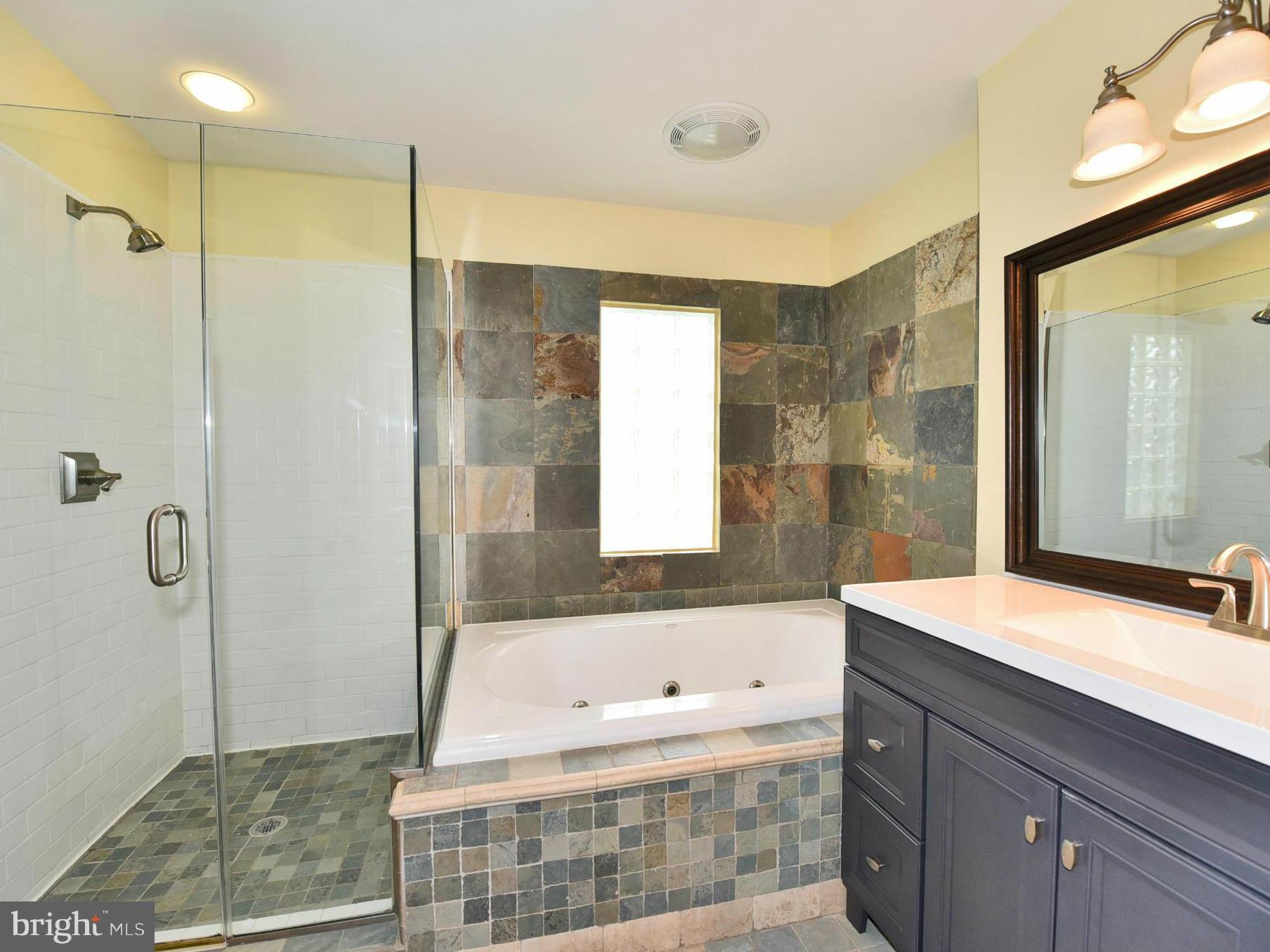 2138 Spencerville Road Spencerville, MD 20868 - Photo 16 of 30 a bathroom with a bathtub shower sink and mirror