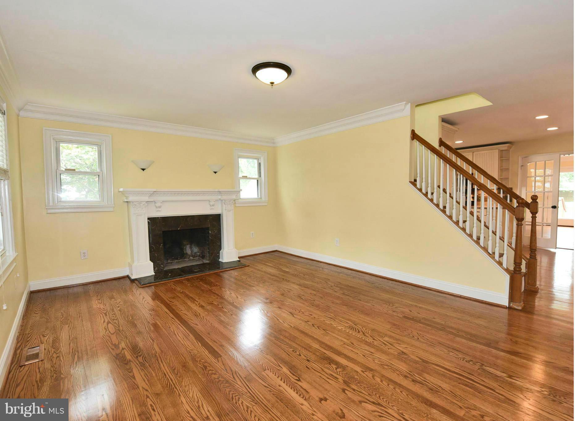 2138 Spencerville Road Spencerville, MD 20868 - Photo 3 of 30 a view of empty room with wooden floor and fireplace