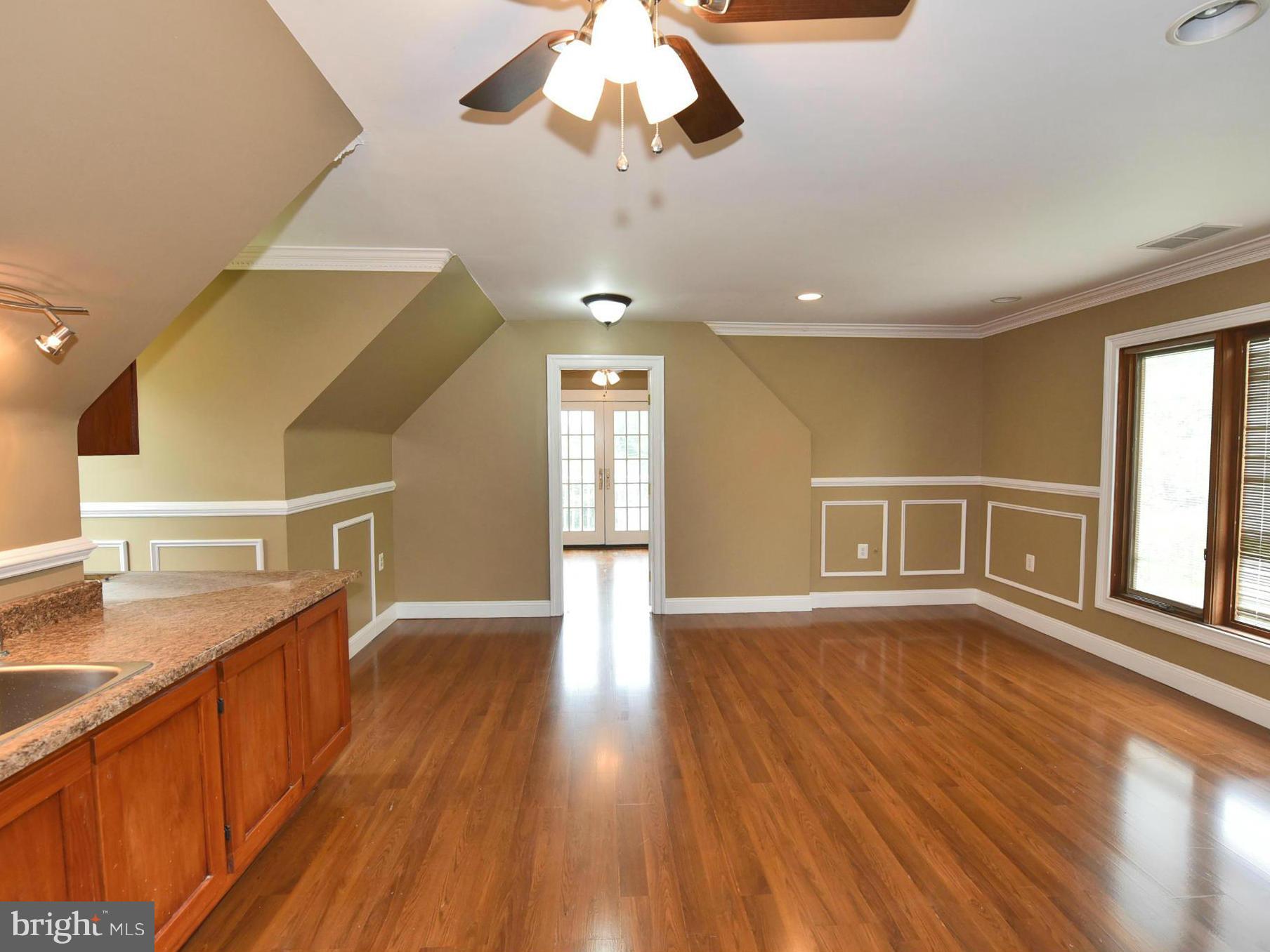 2138 Spencerville Road Spencerville, MD 20868 - Photo 27 of 30 a view of an empty room with wooden floor and a window