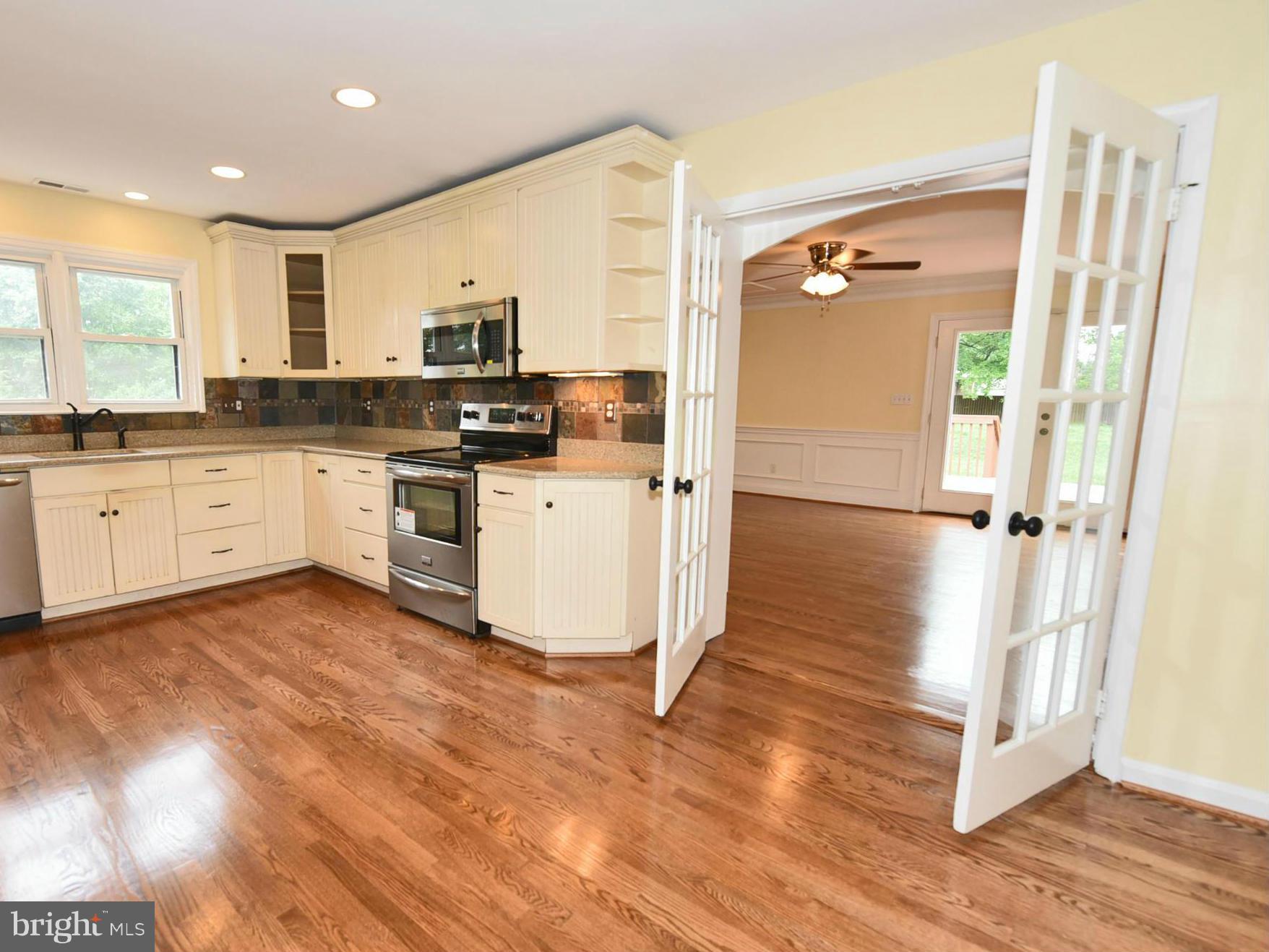 2138 Spencerville Road Spencerville, MD 20868 - Photo 5 of 30 a kitchen with cabinets and wooden floor