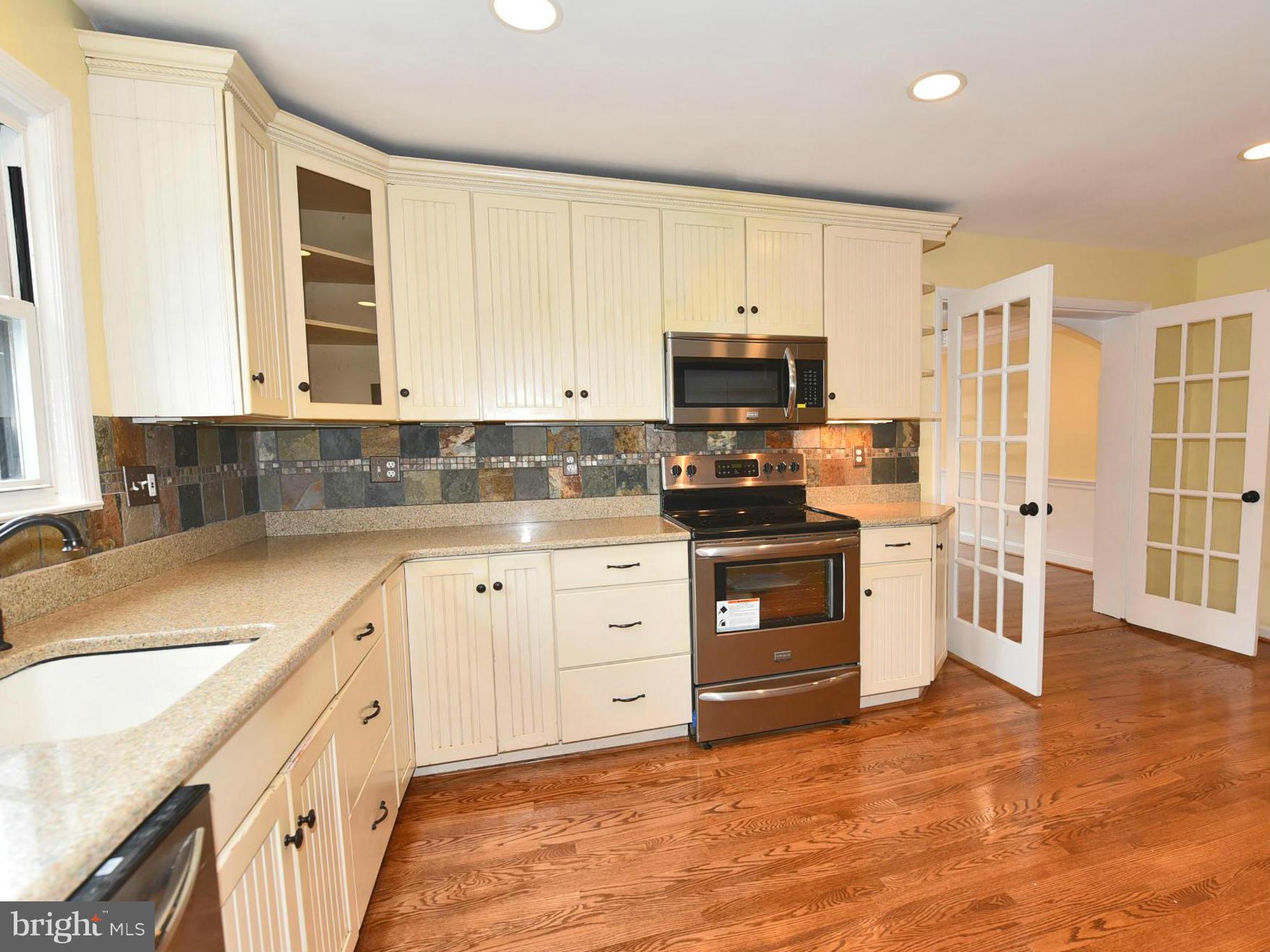 2138 Spencerville Road Spencerville, MD 20868 - Photo 7 of 30 a kitchen with stainless steel appliances a stove a sink and a refrigerator
