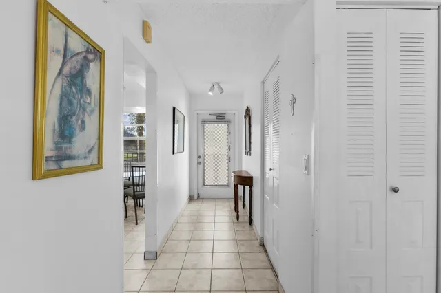 a hallway with wooden floor and windows