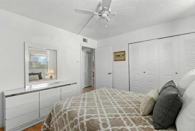 a bedroom with a bed and a large mirror