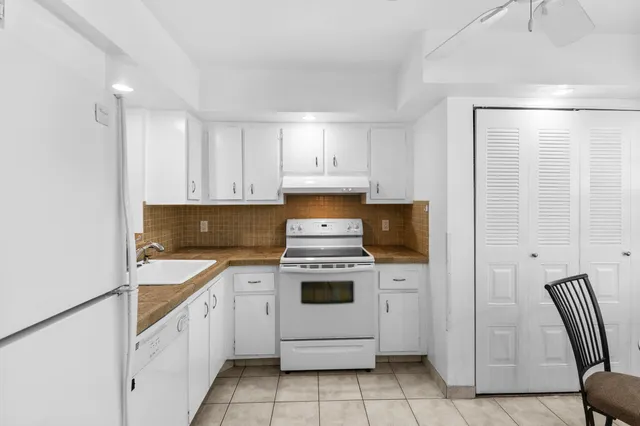 a kitchen with a stove and a refrigerator