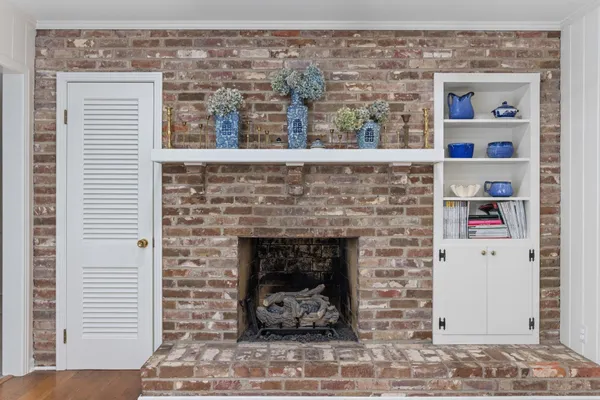 a bathroom with a sink a toilet a shower and a window