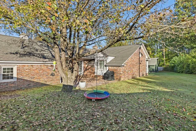 a view of a house with yard and sitting area