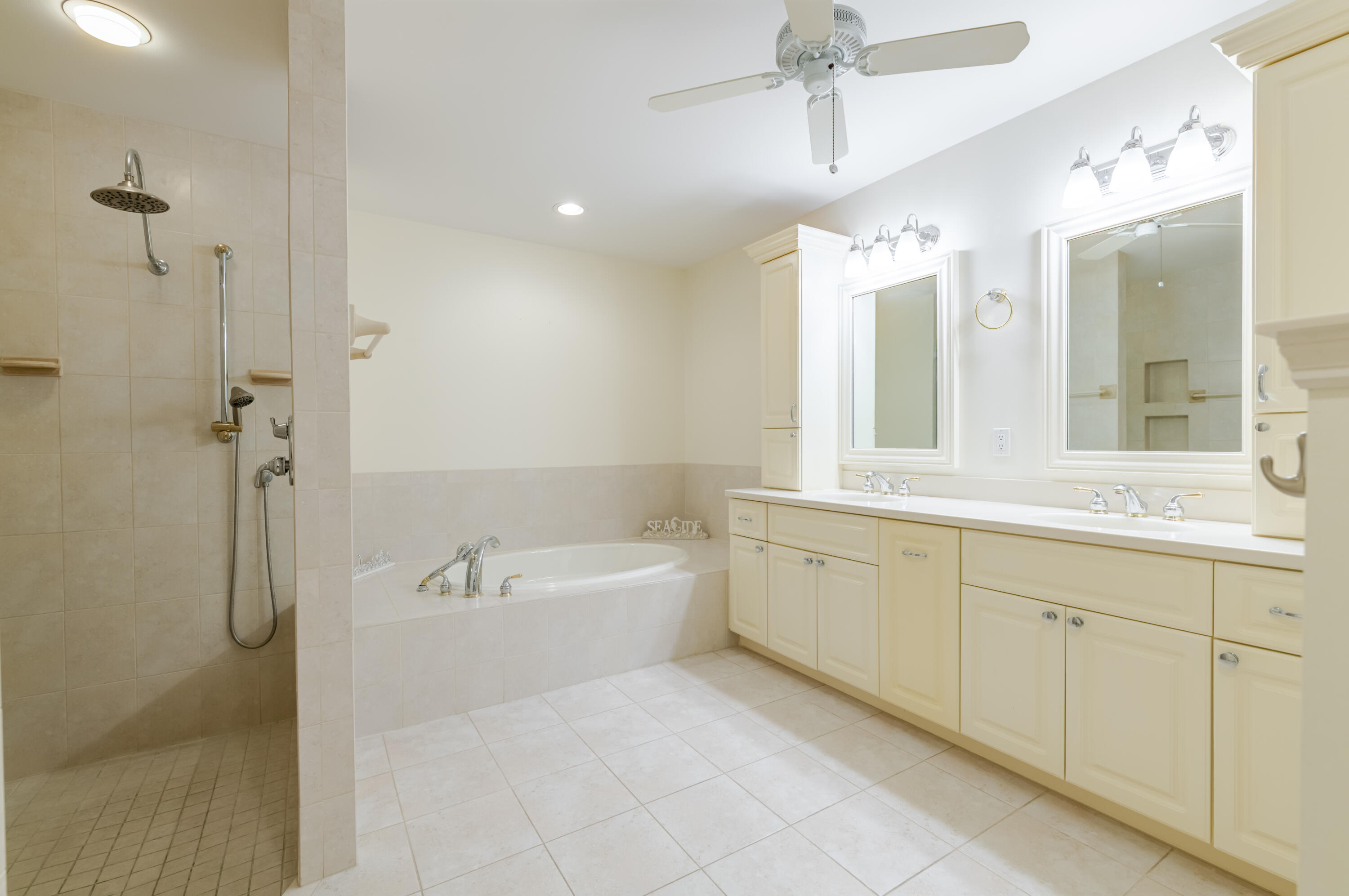 114 Beach Summit Court Jupiter, FL 33477 - Photo 47 of 97 a spacious bathroom with a double vanity sink a mirror and a bathtub
