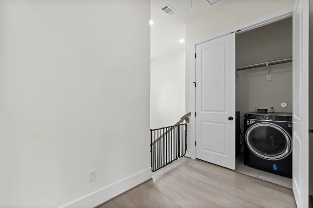 a view of a hallway with washer and dryer