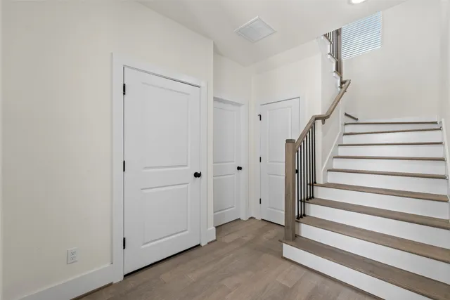 a view of a livingroom with entryway and stairs