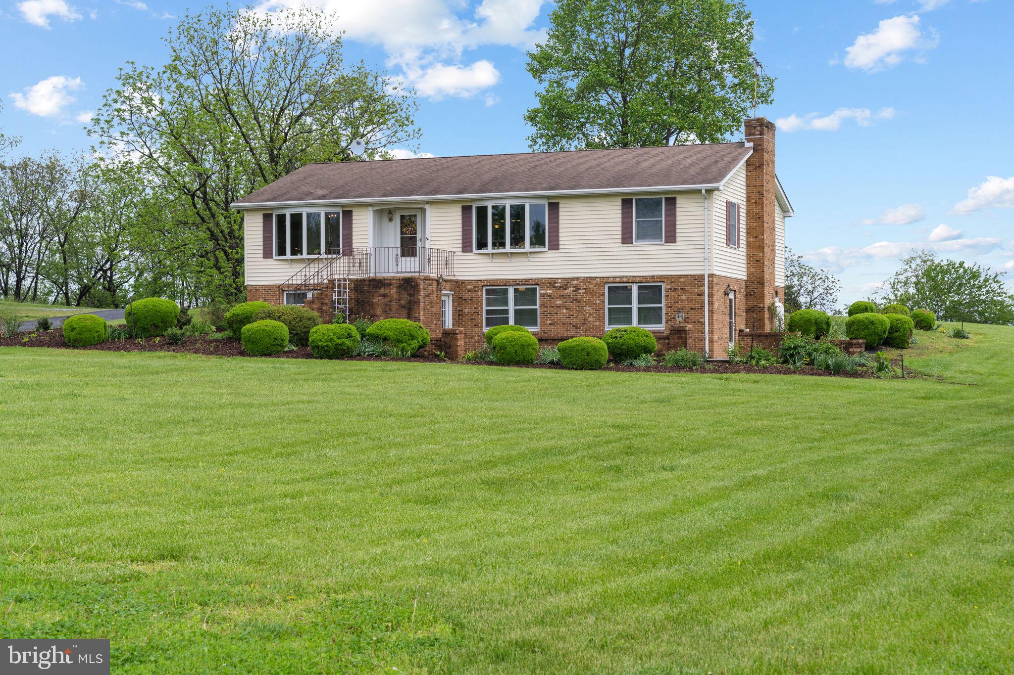 3296 Apple Pie Ridge Road Winchester, VA 22603 - Photo 1 of 61 front view of a house with a garden
