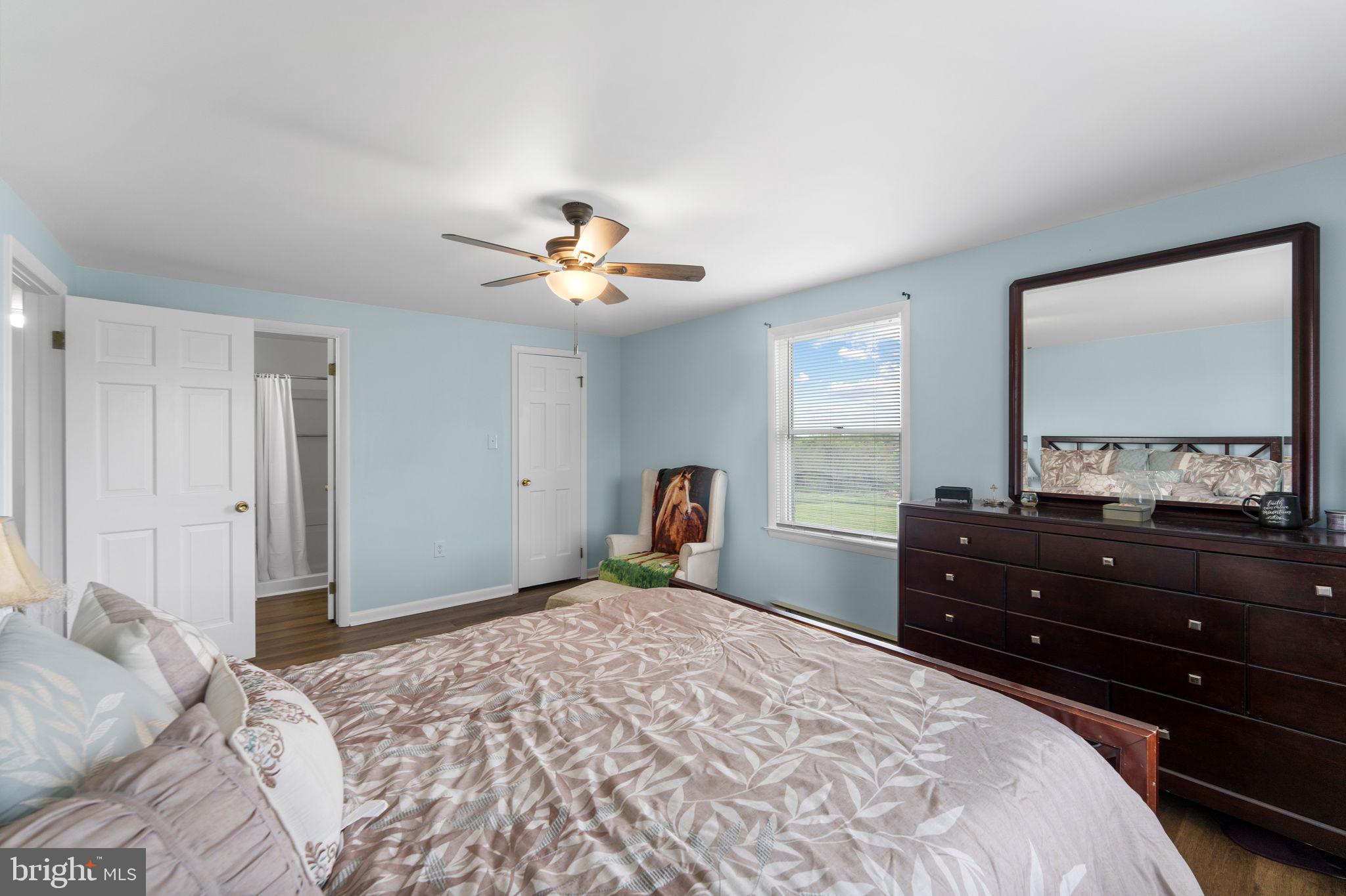 3296 Apple Pie Ridge Road Winchester, VA 22603 - Photo 21 of 61 a bedroom with a bed and a chandelier