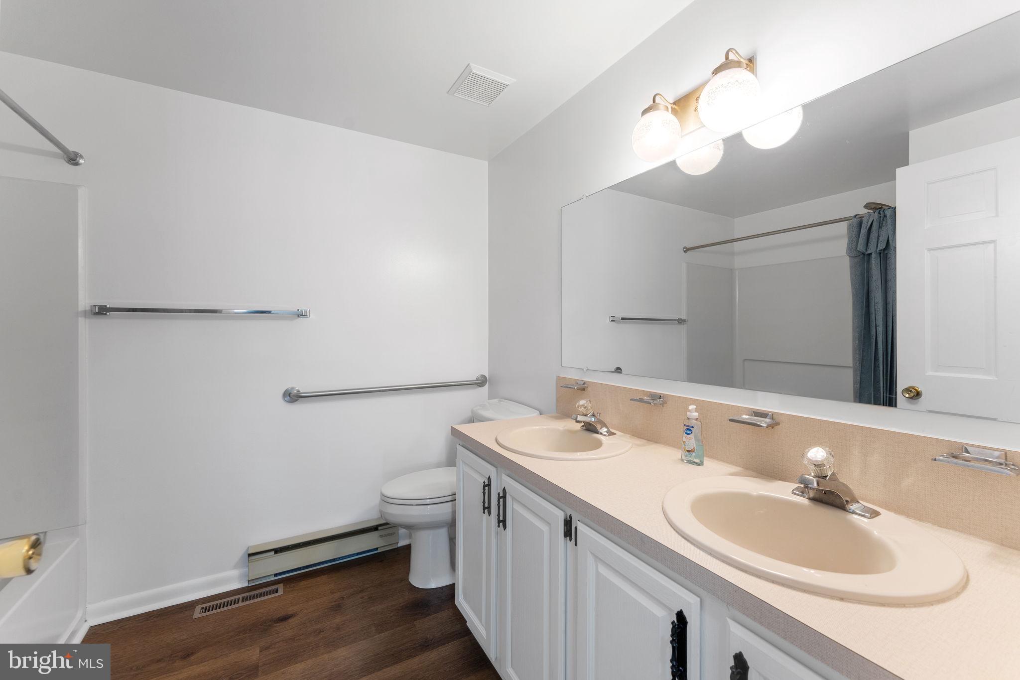 3296 Apple Pie Ridge Road Winchester, VA 22603 - Photo 28 of 61 a bathroom with a double vanity sink and a mirror