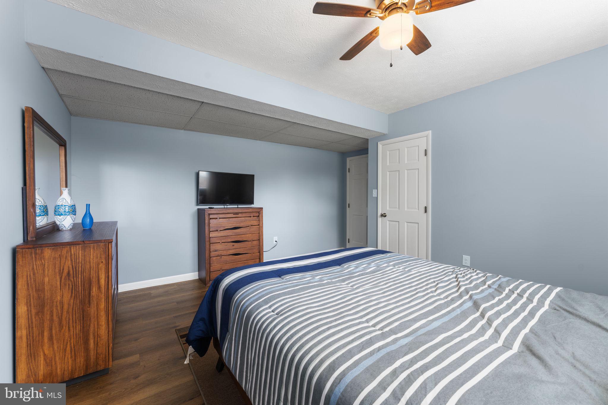 3296 Apple Pie Ridge Road Winchester, VA 22603 - Photo 45 of 61 a bedroom with a bed and wooden floor