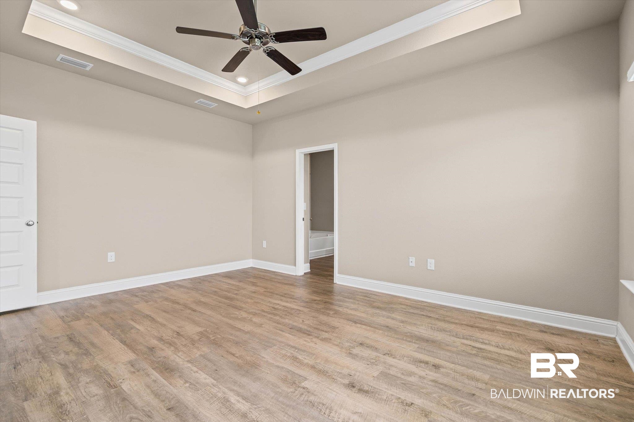 22976 Lieutenant Avenue Foley, AL 36535 - Photo 10 of 30 Unfurnished room featuring a raised ceiling, ornamental molding, light wood-style floors, a ceiling fan, and recessed lighting